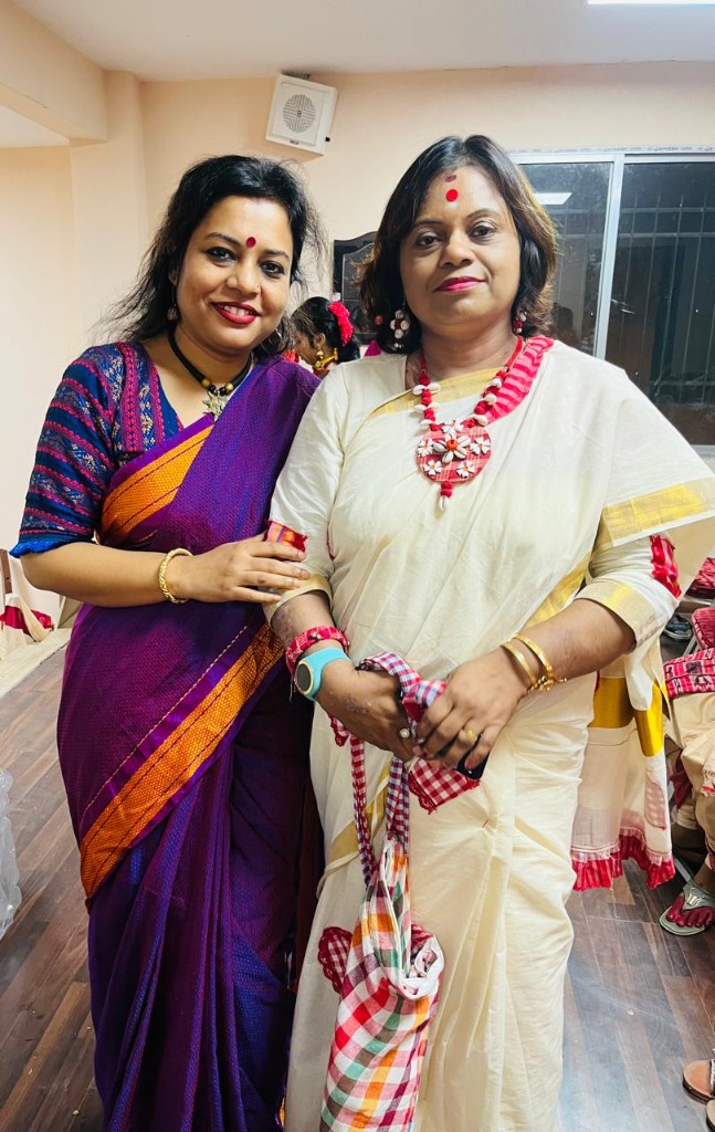 Client in red and white gamcha saree at a cultural programme