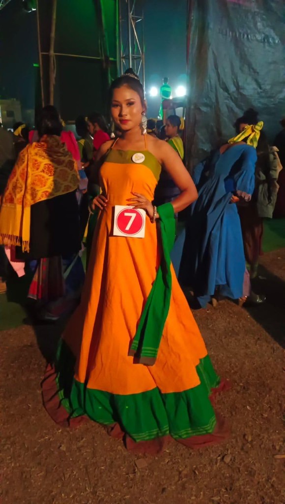 Pageant contestant in orange and green handloom gown