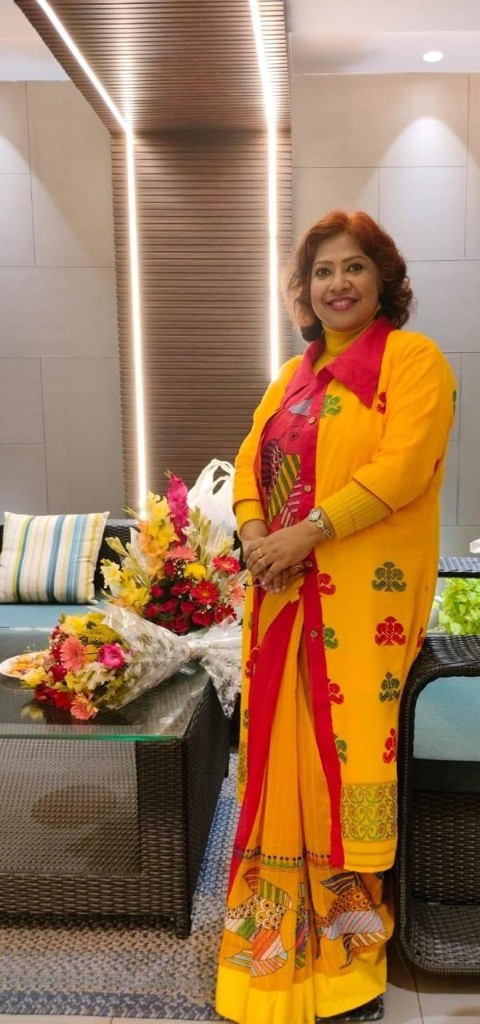 Client in yellow art saree with fish motifs and matching jacket